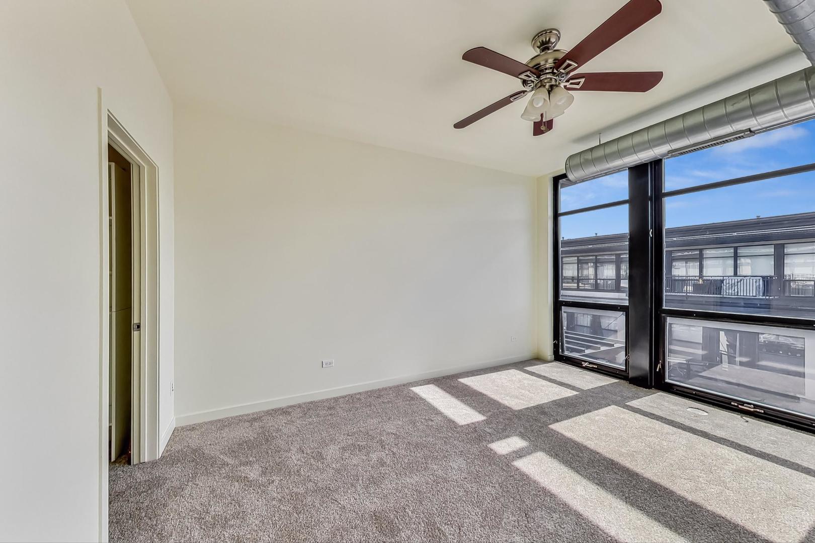 1151 West 14th Place, Unit 404 Chicago, IL 60608 - Photo 9 of 28 a view of an empty room with a window