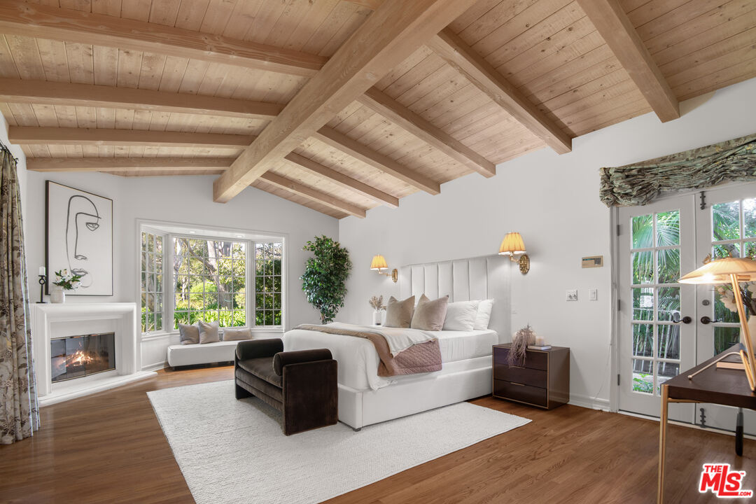6105 Bonsall Drive Malibu, CA 90265 - Photo 15 of 45 a bedroom with furniture and a fireplace