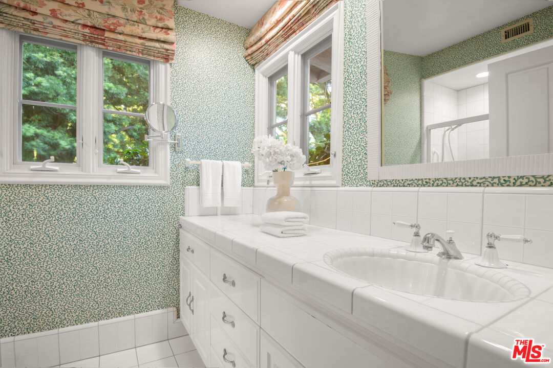 6105 Bonsall Drive Malibu, CA 90265 - Photo 22 of 45 a bathroom with a sink and a mirror