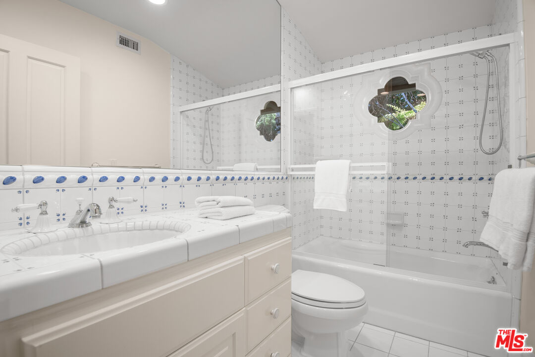6105 Bonsall Drive Malibu, CA 90265 - Photo 25 of 45 a bathroom with a sink and a mirror