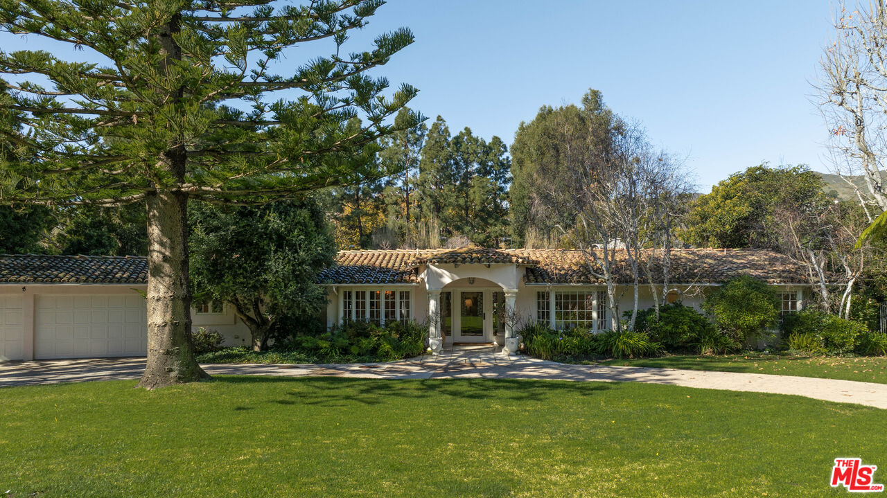 6105 Bonsall Drive Malibu, CA 90265 - Photo 3 of 45 a front view of a house with a garden and trees