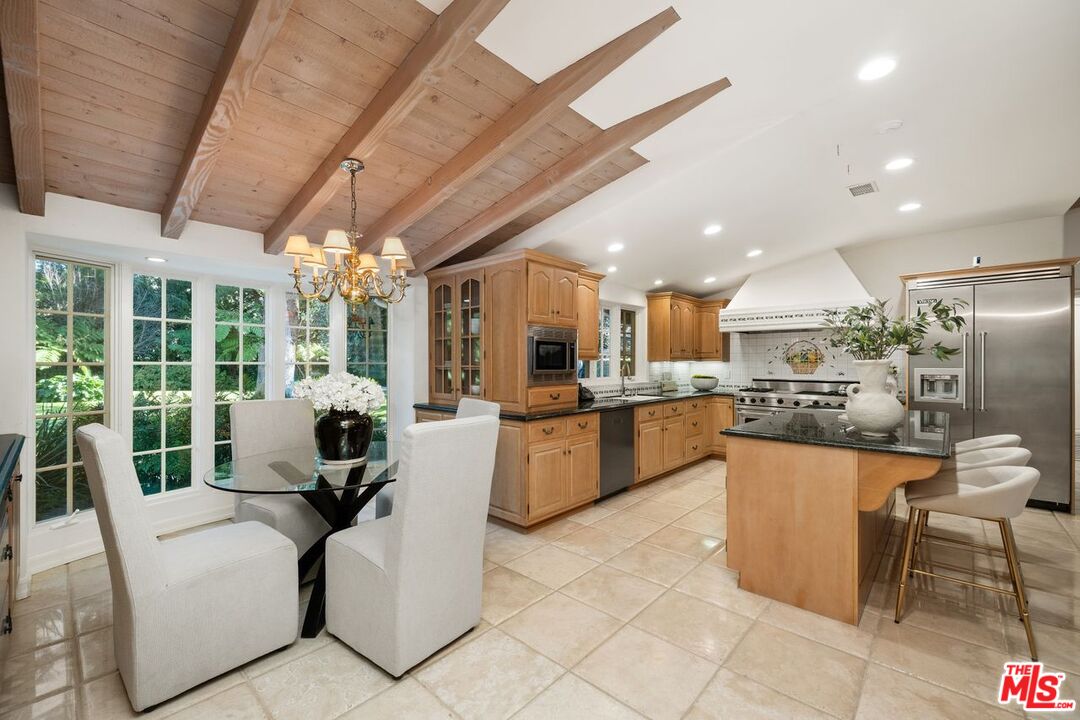 6105 Bonsall Drive Malibu, CA 90265 - Photo 10 of 45 a living room with stainless steel appliances kitchen island granite countertop furniture and a view of kitchen