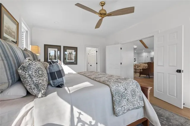 a spacious bedroom with a bed and ceiling fan