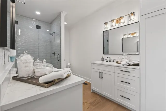 a bathroom with a double vanity sink mirror and shower