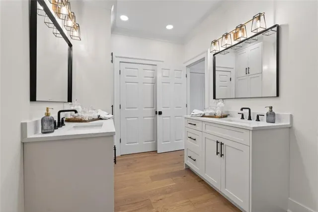 a bathroom with a double vanity sink mirror and
