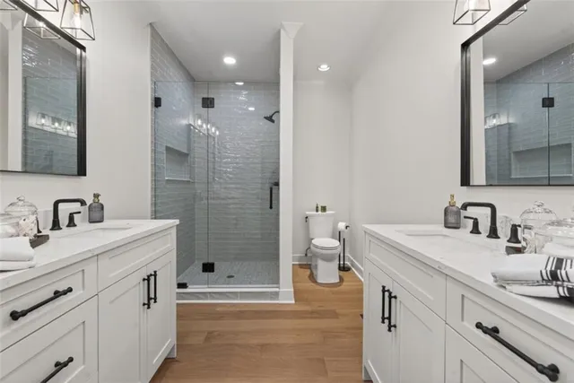 a bathroom with a sink double vanity granite tub and shower