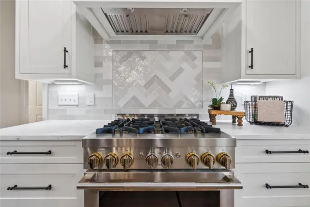 a kitchen with a stove and cabinets