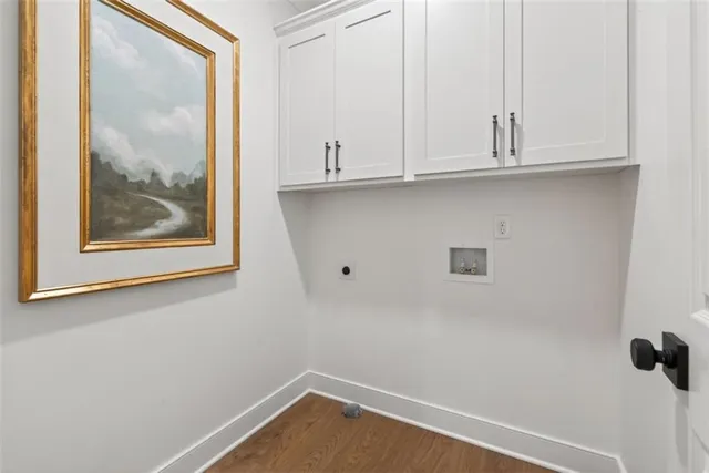 a view of a small space with wooden floor and white walls