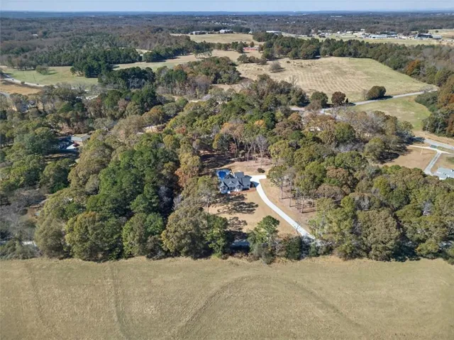 an aerial view of a house with a yard