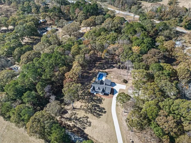 a view of a yard with large trees