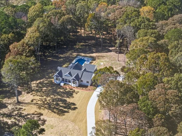 a view of a backyard with swimming pool