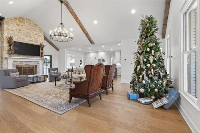 a living room with furniture and a chandelier