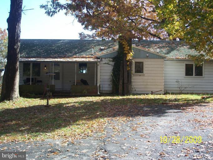 3715 Abingdon Beach Road Abingdon, MD 21009 - Photo 6 of 7 a view of a brick house next to a yard with large tree