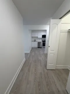 a view of a kitchen with wooden floor and electronic appliances