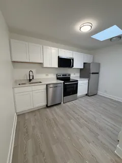 a kitchen with a sink a stove and cabinets