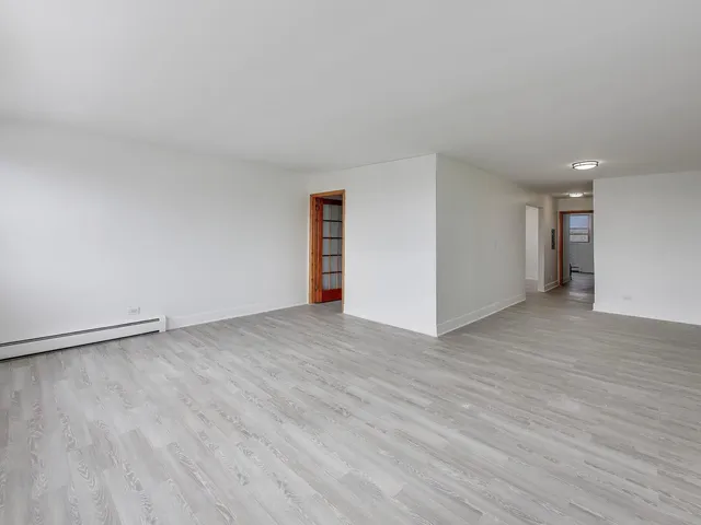 a view of an empty room and wooden floor