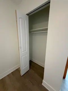 an empty room with wooden floor