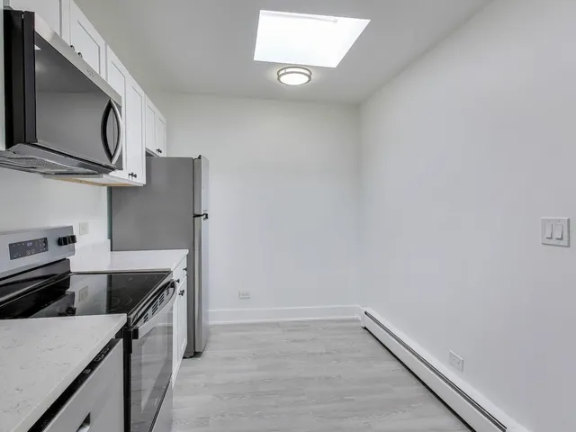 a kitchen with a sink and refrigerator