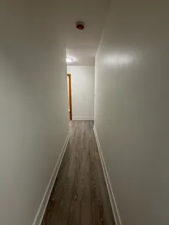 a view of hallway with wooden floor