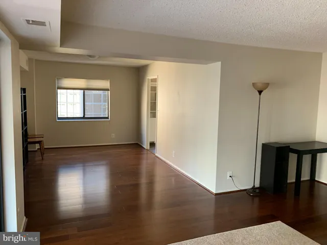 an entryway with a window and wooden floor
