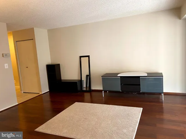 a view of bathroom with a shower and closet