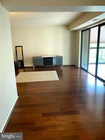 a view of a room with wooden floor and a window