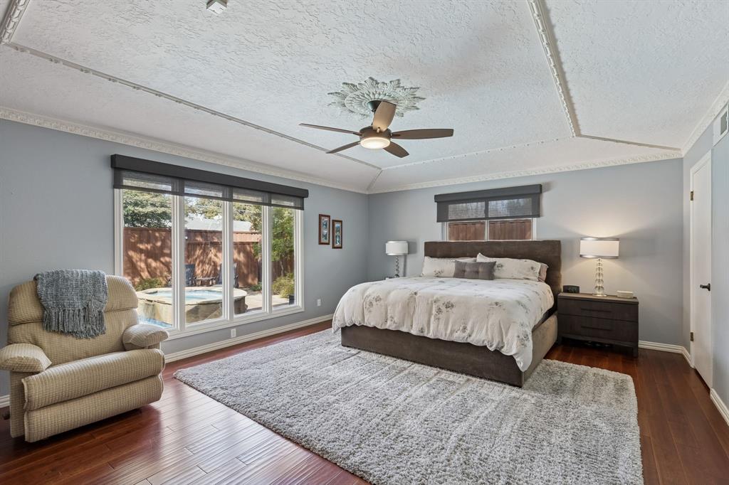 4475 Twin Post Road Dallas, TX 75244 - Photo 9 of 10 a spacious bedroom with a bed a couch and a couch with wooden floor