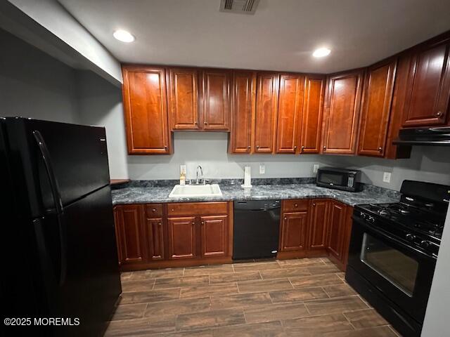 216 Ocean Gate Avenue, Unit 2 Ocean Gate, NJ 08740 - Photo 4 of 17 a kitchen with stainless steel appliances granite countertop wooden cabinets a stove top oven a sink and dishwasher