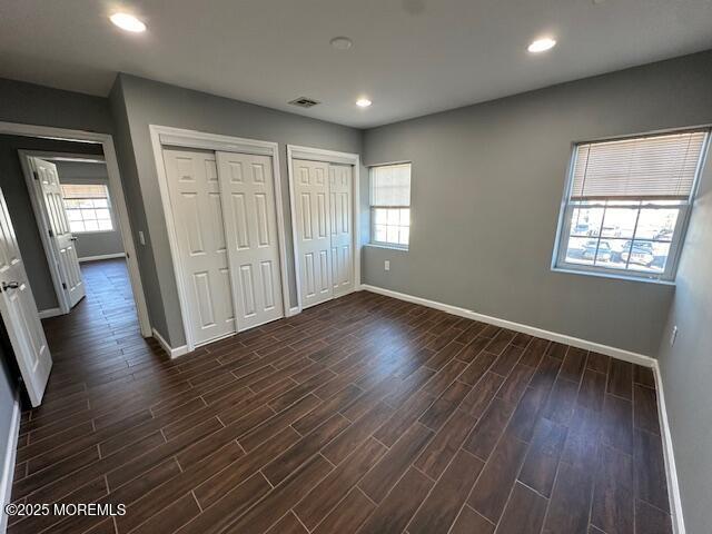 216 Ocean Gate Avenue, Unit 2 Ocean Gate, NJ 08740 - Photo 9 of 17 an empty room with wooden floor and windows