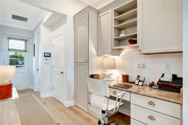 a living room with furniture fireplace and a large window