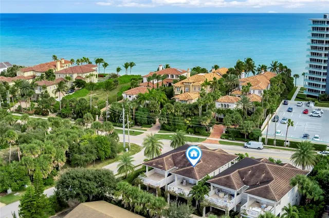 a front view of a house with a yard and green space