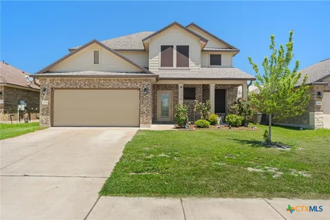 a front view of a house with a garden and plants