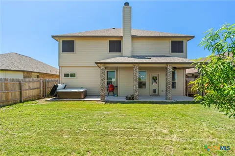 a view of a house with a yard and sitting area