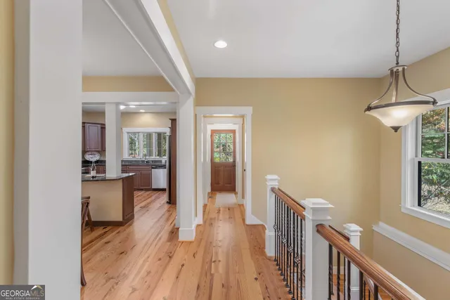 a kitchen with stainless steel appliances granite countertop a refrigerator a stove and a wooden floors