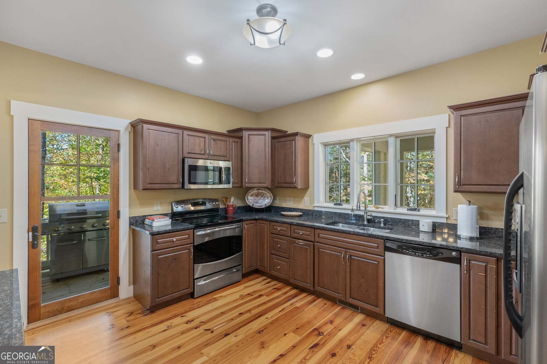 2473 Highland Gap Road Scaly Mountain, NC 28775 - Photo 17 of 93 a kitchen with stainless steel appliances granite countertop wooden cabinets a sink and a stove