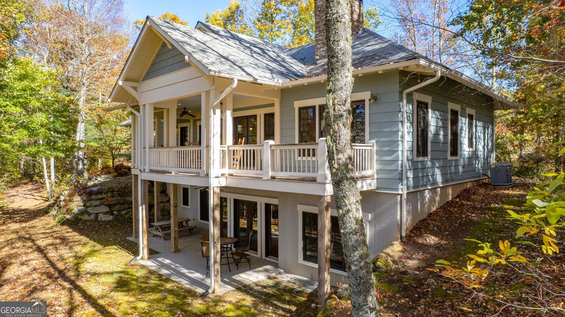 2473 Highland Gap Road Scaly Mountain, NC 28775 - Photo 28 of 93 a view of a white house with large windows and table and chairs