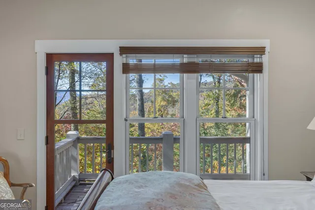 a bed sitting in a bedroom next to a window