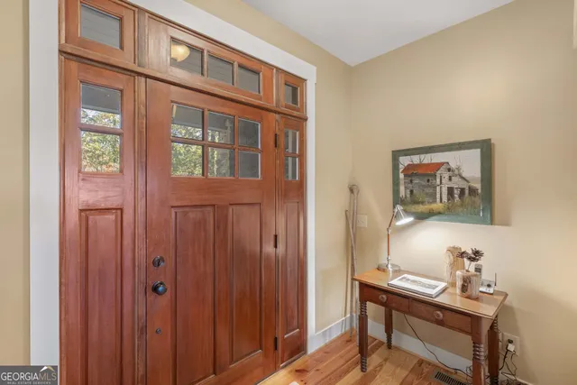 a living room with furniture a large window and a fireplace