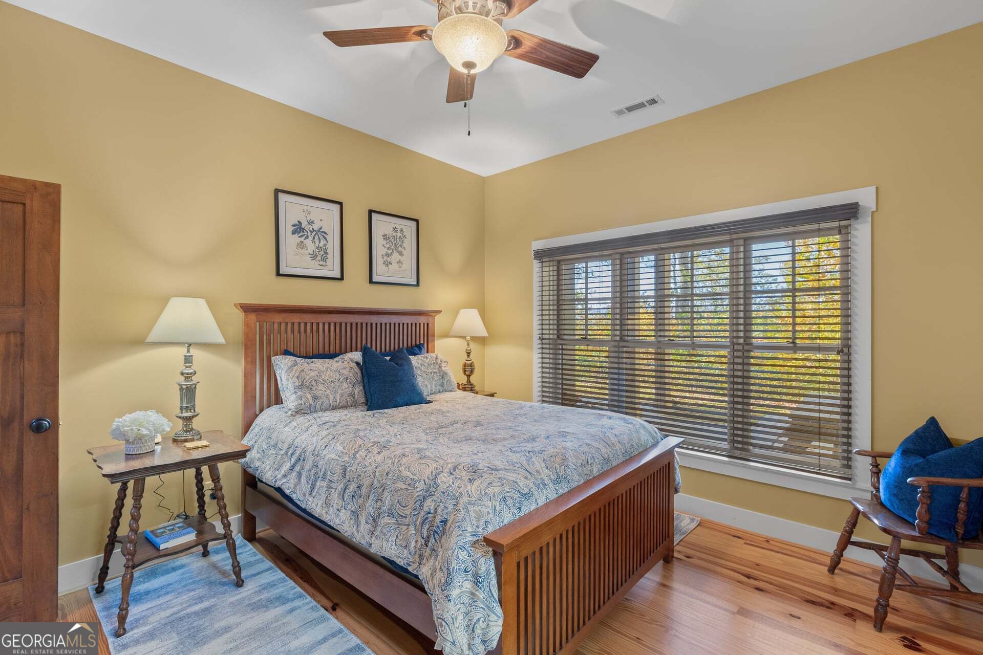 2473 Highland Gap Road Scaly Mountain, NC 28775 - Photo 62 of 93 a bedroom with a bed and a chandelier