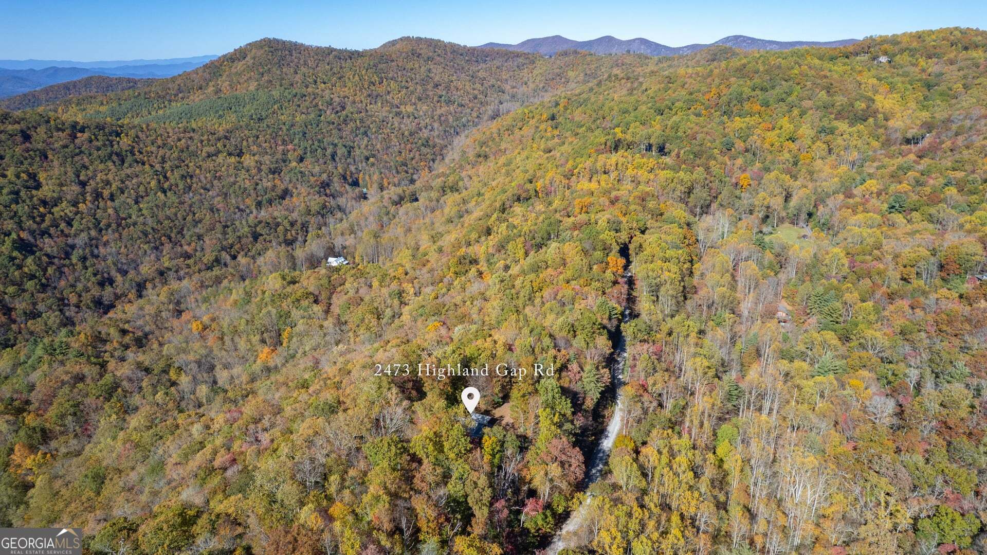 2473 Highland Gap Road Scaly Mountain, NC 28775 - Photo 86 of 93 a view of a dry yard with mountains in the background