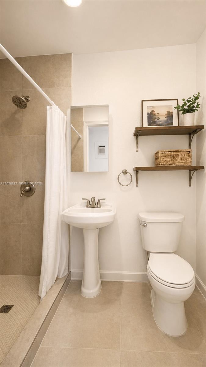 2727 Southwest 24th Street Miami, FL 33145 - Photo 17 of 18 a white toilet sitting next to a bathroom sink