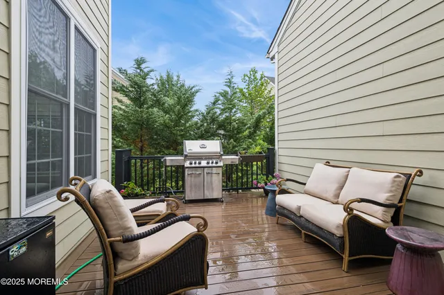 a view of a patio with couches chairs and wooden floor