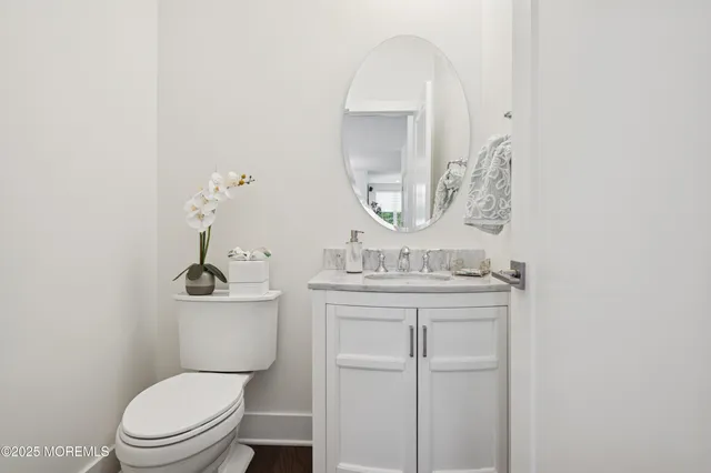 a bathroom with a toilet a sink and mirror