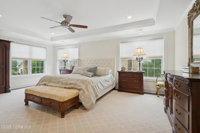 a spacious bedroom with a bed and large window