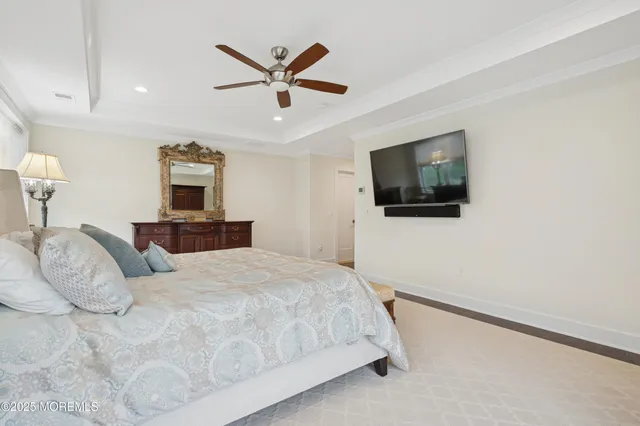 a bedroom with a large bed and a flat screen tv