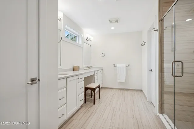 a bathroom with a sink a mirror and a shower