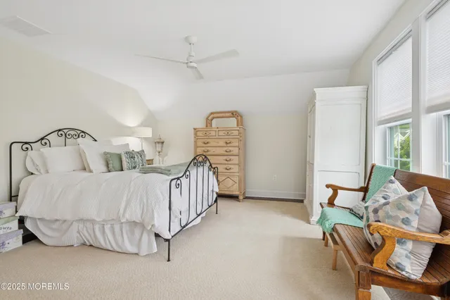 a bedroom with a bed window and chair