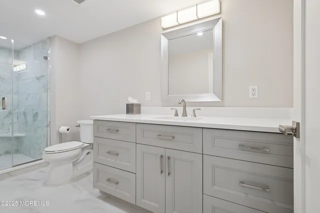 a bathroom with 2 sink toilet and shower