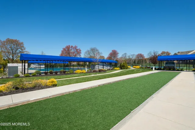 a view of green field with house in the background