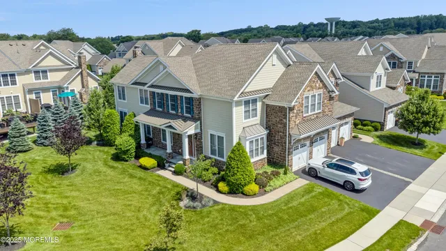 an aerial view of a house with yard and lake view